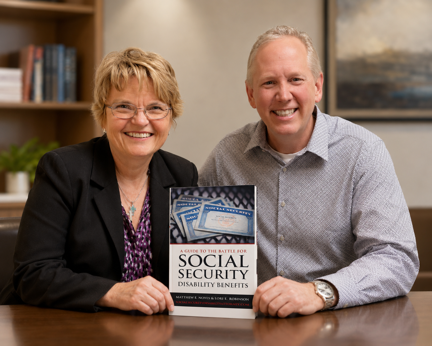 Social Security Disability Attorneys Matthew Noyes and Lorraine Robinson with their book on the SSDI process